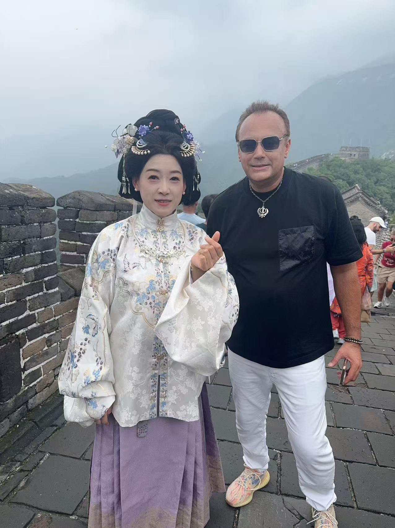 A guest meeting a local host on the Great Wall of China
